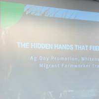 Student presenting on migrant agricultural laborers as "the hidden hands that feed America."